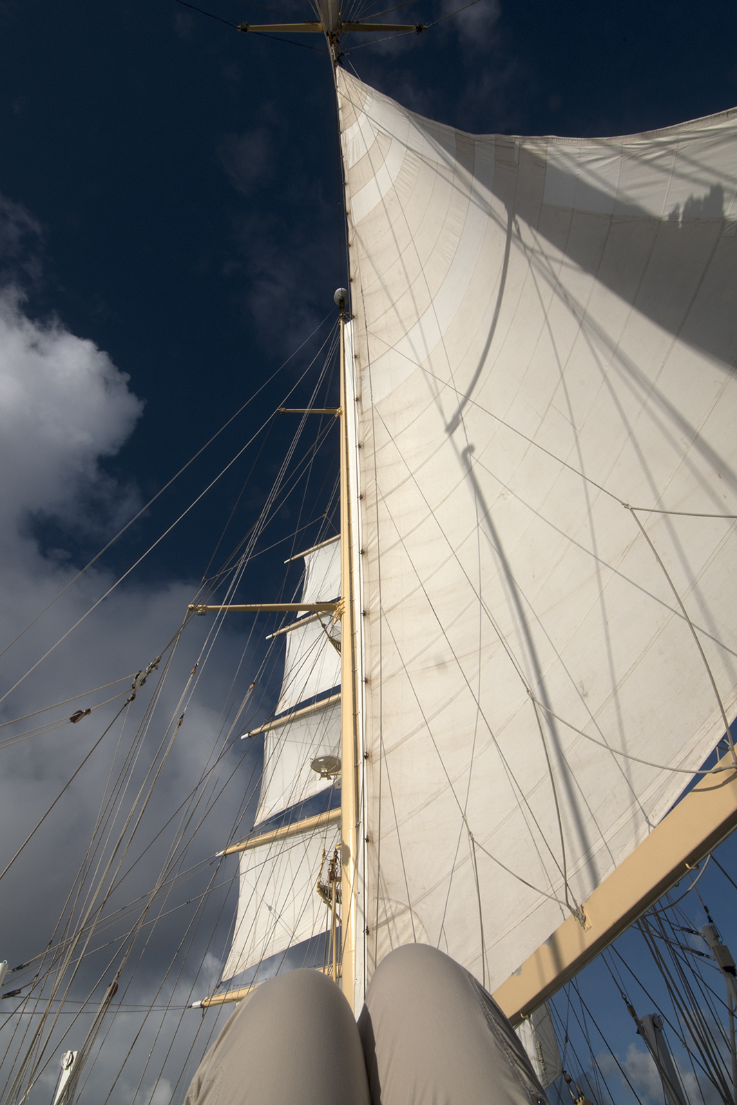 Lounging on deck, looking up at the sails and the sky. Photograph, Ann Fisher.