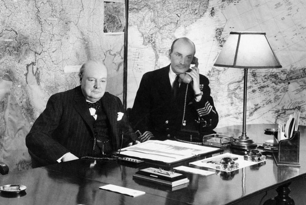 Winston Churchill in the Map Room, July 1945, with and Captain RP Pim next to him.