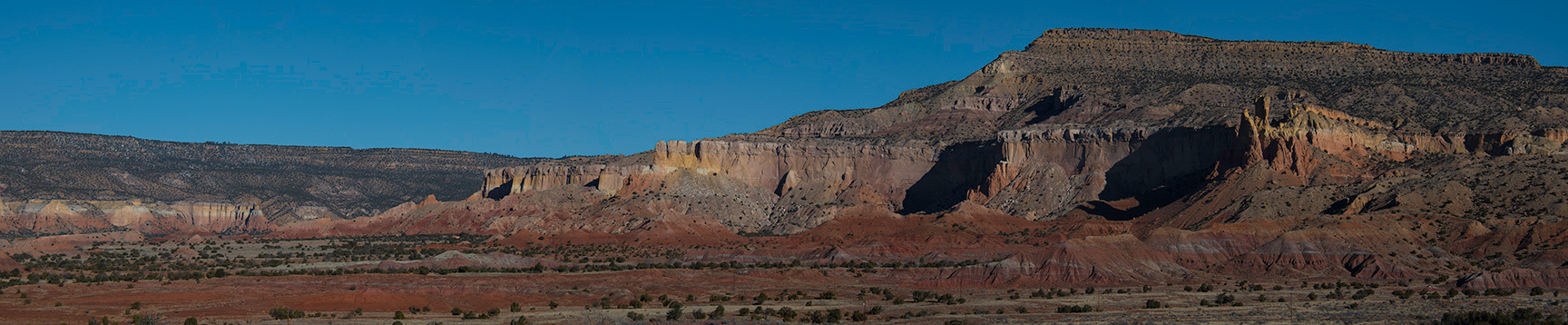 Panoramic view, looking towards the red rock formations at Ghost Ranch.