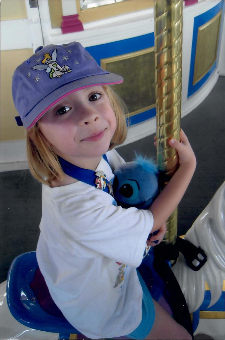 Catherine and Stitch ride Cinderella's Carousel in 2004.
