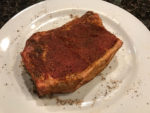 Seasoning steak with west texas steak rub