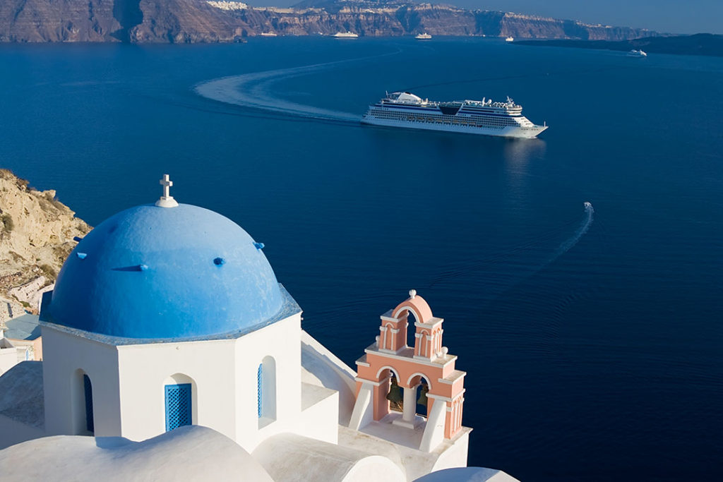 Cruise ship sails through the islands of Greece. 