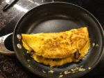 Use a spatula to flip the empty side of the omelette over the full side.
