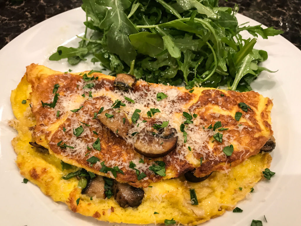 Omelette for supper: Cremini mushrooms, scallions, and Parmigiano cheese