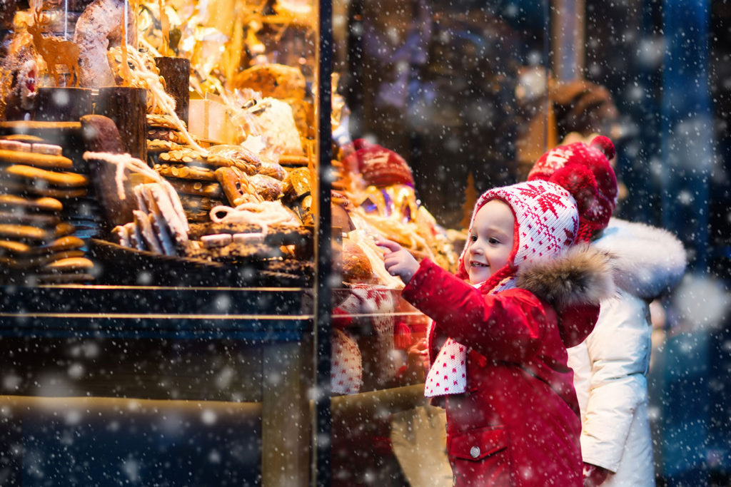 A little girl choosing a cookie at the Christmas Market in Munich