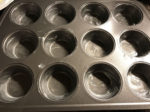 Muffin pan greased with butter
