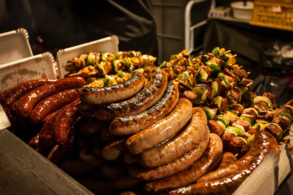 Sausages and skewers of meat and vegetables at a street kiosk in Prague