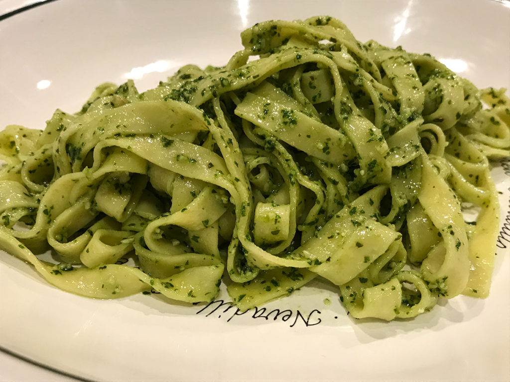 Fettuccine tossed with a pesto, made with basil and pine nuts,